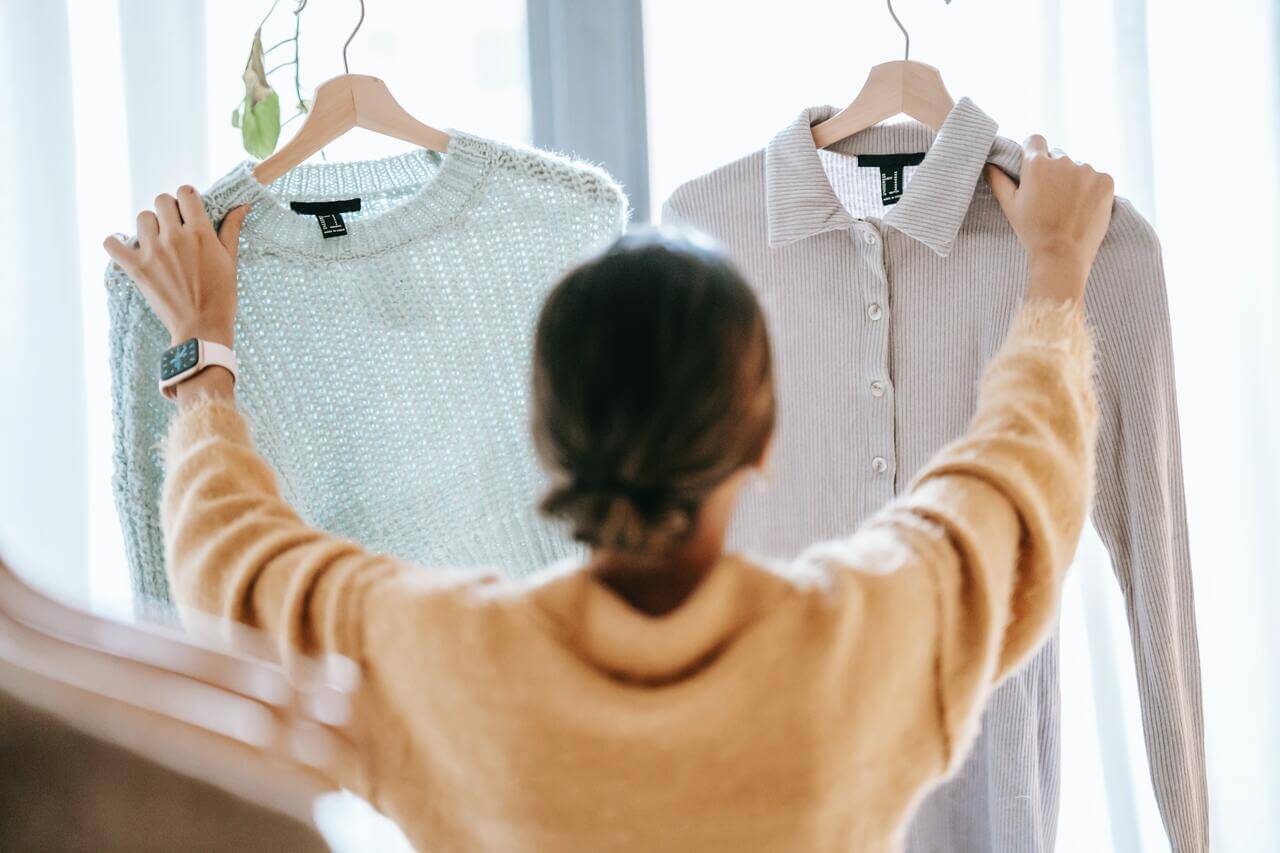 Woman choosing between two shirts